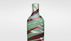 A glass vase by Carlo Scarpa with green and red swirls of color.